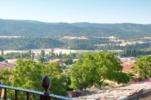 a view of a town from a balcony with trees at El Mirador de la Serrania in Villalba de la Sierra