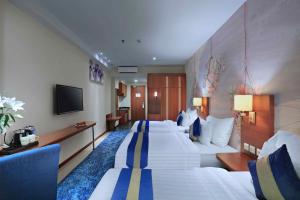 Letto o letti in una camera di Aston Inn Gideon Batam
