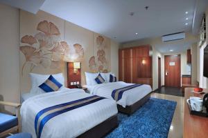Letto o letti in una camera di Aston Inn Gideon Batam