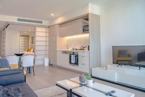 a living room with a couch and a table at AirTrip Apartments on Tribune Street in Brisbane