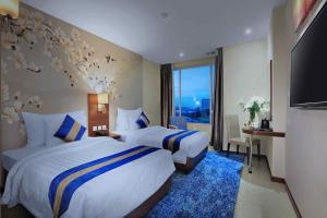 Letto o letti in una camera di Aston Inn Gideon Batam