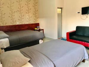 Penginapan Intan Bandara客房内的一张或多张床位