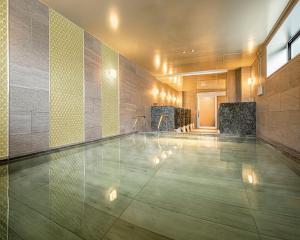 a swimming pool in a building with a pool at Rihga Gran Kyoto in Kyoto
