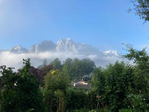 - une vue sur une chaîne de montagnes avec des nuages et des arbres dans l'établissement Ferienwohnung Sophia, à Grainau