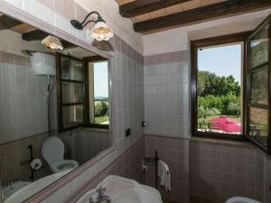 a bathroom with a sink and a toilet and a mirror at Agriturismo a Montoro vicino al mare in Narni +32 photos