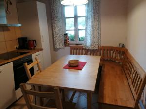 a kitchen with a wooden table with a bowl on it at Ferienwohnungen Wastl Fränkische Schweiz in Hiltpoltstein