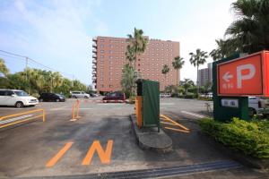 a parking lot in a parking lot with a parking meter at Richmond Hotel Miyazakiekimae in Miyazaki