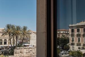 a view of a city from a window at Spa sul tempio d'apollo in Siracusa