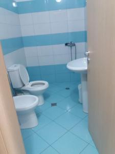 a bathroom with two toilets and a sink at Apartamente-Danaj Radhime in Vlorë