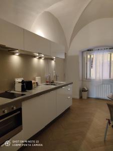 een keuken met witte kasten en een aanrecht bij Appartement quartier du vieux port de Bastia in Bastia