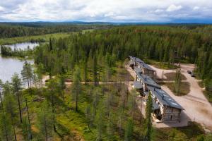 an aerial view of a cabin in the woods next to a lake at Veskaranta Sky View Villas in Ruka