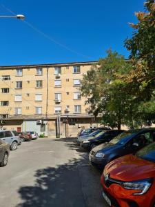 a parking lot with cars parked in front of a building at Mia Apartament in Tulcea