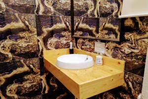 a bathroom with a wooden sink in a wall at Monallan Boracay Hotel in Boracay