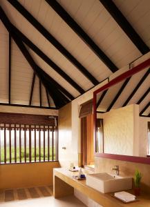 a bathroom with a sink and a large window at Jetwing Kaduruketha in Wellawaya