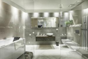 a bathroom with a sink and a tub and a toilet at Dimora storica - Palazzo del Taja in Siena