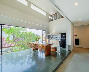 a kitchen and dining room with a table and chairs at M Studio Karawaci in Tangerang
