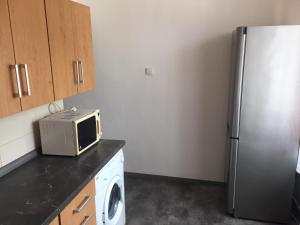 a kitchen with a microwave and a refrigerator at Apartmán Melody in Ústí nad Labem