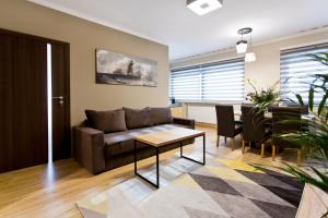 a living room with a couch and a table at Hotel CONRAD Comfort in Krakow