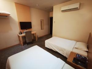 Postel nebo postele na pokoji v ubytování Prescott Hotel Bukit Bintang