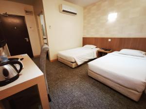 Postel nebo postele na pokoji v ubytování Prescott Hotel Bukit Bintang