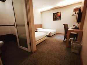 Postel nebo postele na pokoji v ubytování Prescott Hotel Bukit Bintang