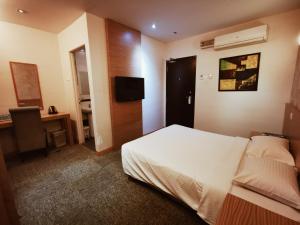 Postel nebo postele na pokoji v ubytování Prescott Hotel Bukit Bintang