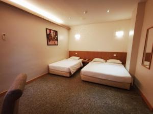 Postel nebo postele na pokoji v ubytování Prescott Hotel Bukit Bintang