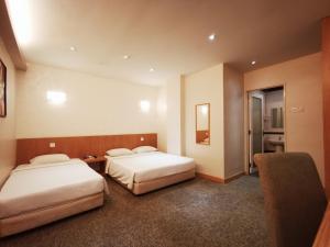 Postel nebo postele na pokoji v ubytování Prescott Hotel Bukit Bintang