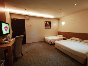 Postel nebo postele na pokoji v ubytování Prescott Hotel Bukit Bintang