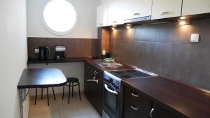 a kitchen with a sink and a stove top oven at JP Apartament Gdynia Centrum in Gdynia
