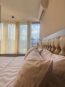 a bedroom with a large bed with a large window at Hotel Kolonja's in Debar