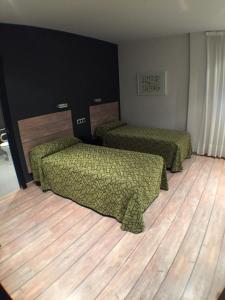 Łóżko lub łóżka w pokoju w obiekcie Rey Don Sancho