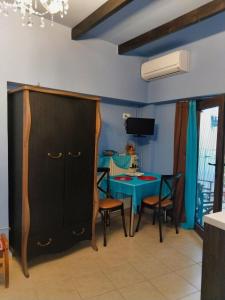 a dining room with a table and a cabinet at Mama's Cozy Room 1 in Kalabaka