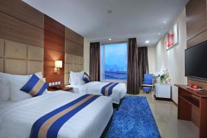 Letto o letti in una camera di Aston Inn Gideon Batam