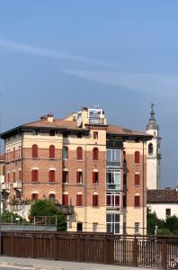 a large brick building with a clock tower in the background at Il Loft di Vanni in Vicenza