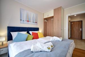 Ένα ή περισσότερα κρεβάτια σε δωμάτιο στο Apartamenty Bel Mare SeaView by Rent like home