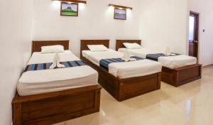 A bed or beds in a room at Four Points Resort - Anuradhapura