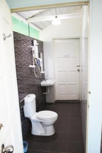 a bathroom with a toilet and a sink at 1511 Coconut Grove in Tioman Island