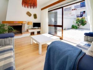 sala de estar con mesa y chimenea en Soothing Holiday Home in Ferrel near Baleal Island, en Ferrel