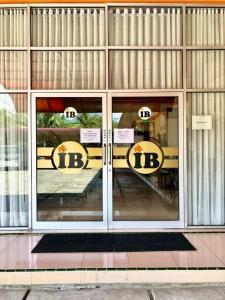 a front door of a building with signs in the windows at Penginapan Intan Bandara in Duku