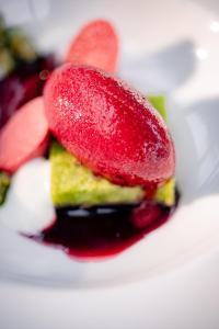 a close up of a dessert with fruit on it at Parkhotel Herne in Herne