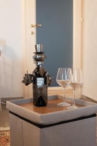 a table topped with two wine glasses and a bottle at I Due Cipressi in Torrenieri