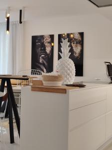 a kitchen with a table with a pineapple on a dresser at Marbella GOLF & SEA LODGE in Estepona