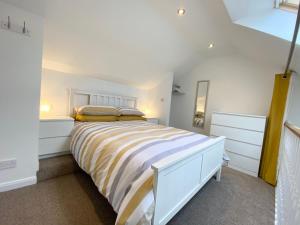 a bedroom with a large white bed in a room at Sunsets In Porthtowan, Cornwall Coastal Holidays in Porthtowan