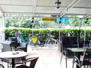 un restaurante con mesas, sillas y bicicletas estacionadas fuera en Locanda Diana, en Iseo