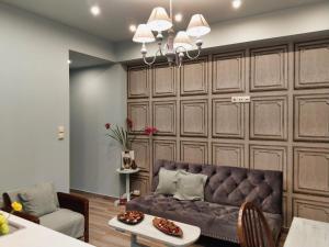 a living room with a couch and a table at Mama's Cozy Room 2 in Kalabaka +25 photos