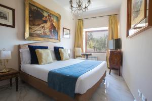 a bedroom with a bed and a painting on the wall at Il Monastero Collection in Rome