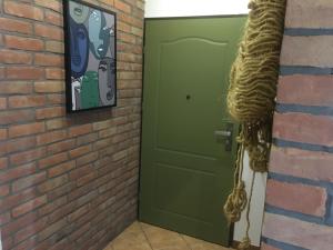 una porta verde accanto a un muro di mattoni di Studio Korona a Mrągowo