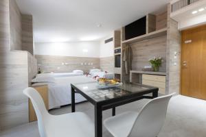 a bedroom with a bed and a table and chairs at Eurohotel in Milan
