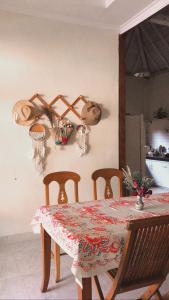 a dining room table with a table and chairs and a kitchen at Villa Pondok Joglo in Yogyakarta